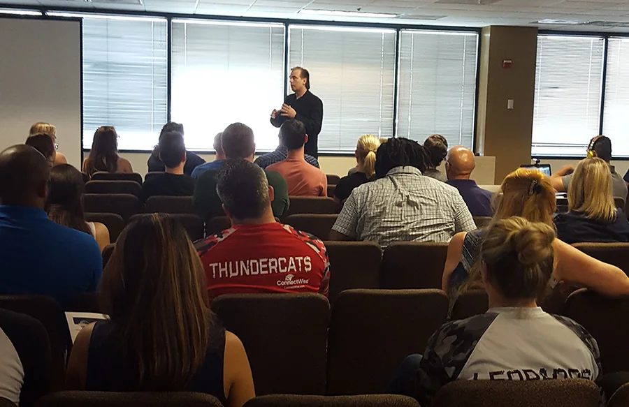 Toby facilitating a workshop for a seated business audience.