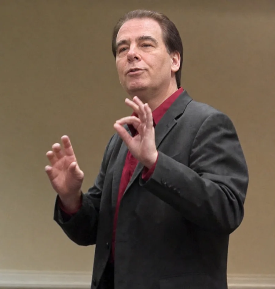 Toby Martini speaking and gesturing during a presentation.