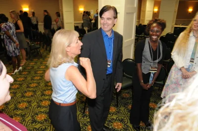 Toby talking with participants during a small-group business workshop.